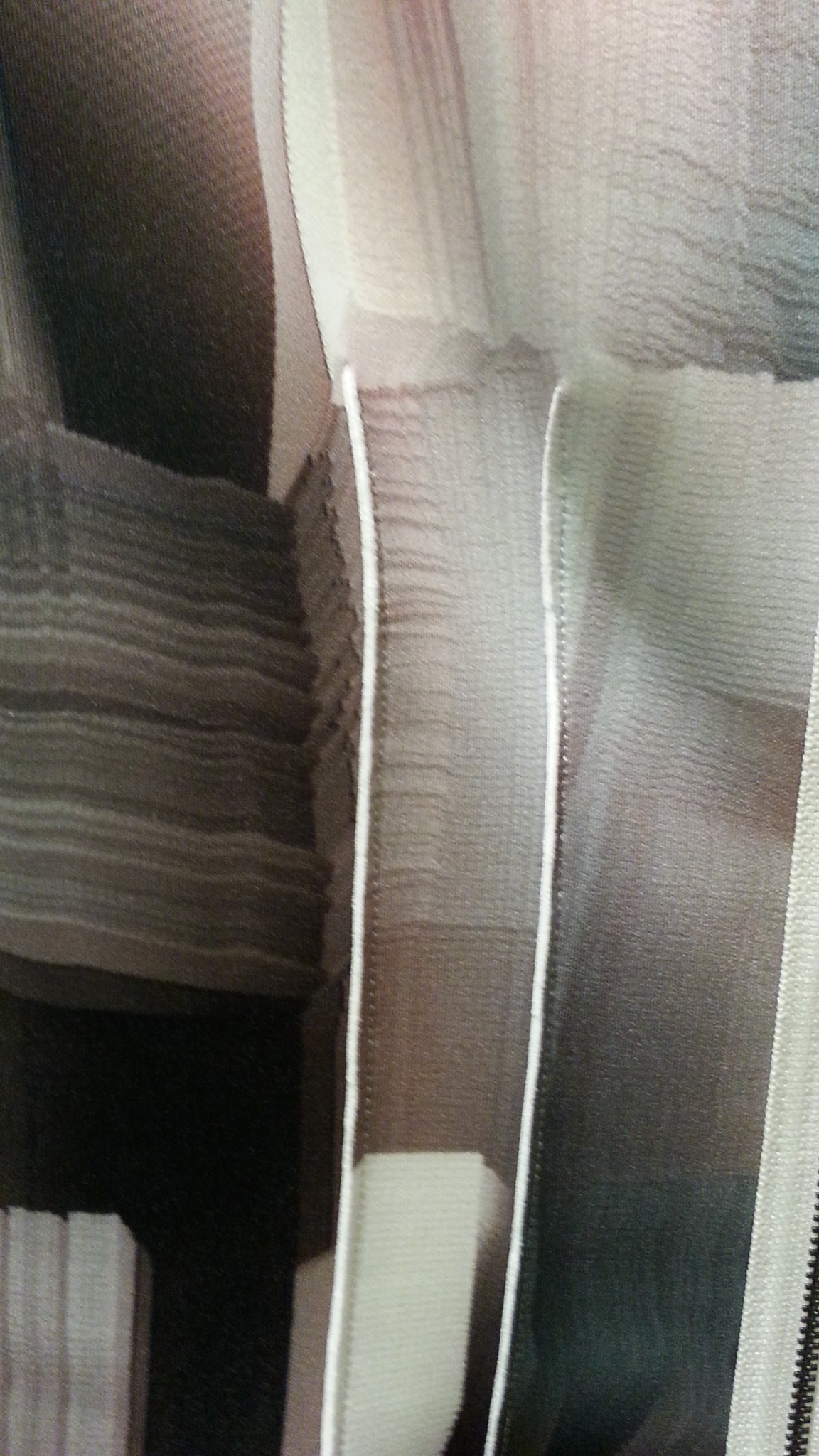 Close up of lapped seam dart on Tahari RTW; the white portion is the solid wrong side of fabric